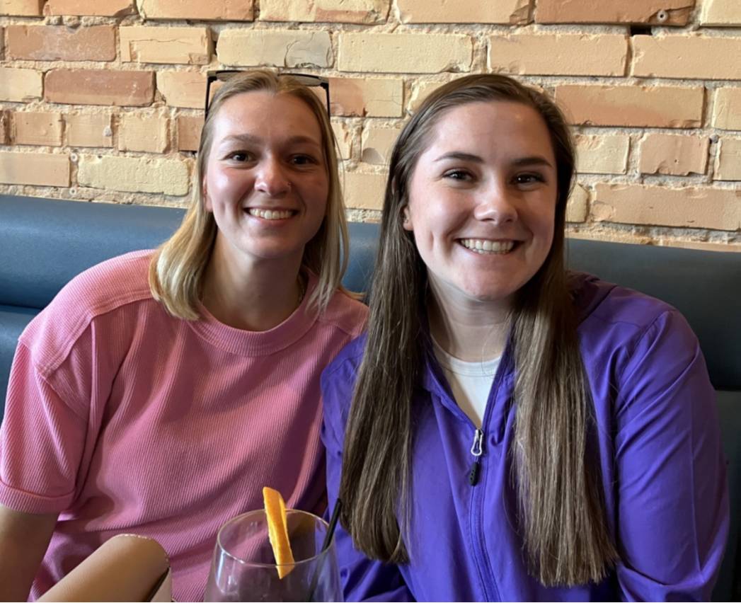 Two students sitting at a restaurant booth